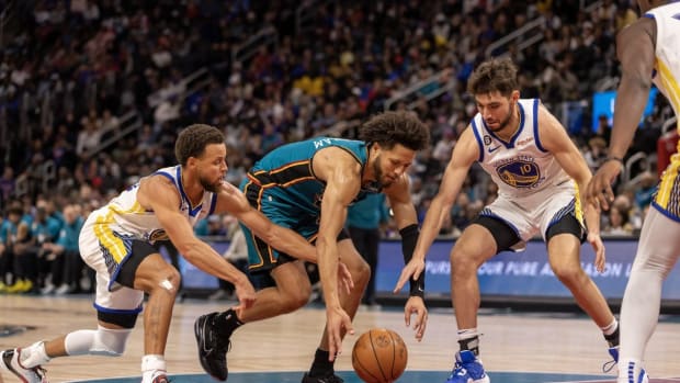 Oct 30, 2022; Detroit, Michigan, USA; Detroit Pistons guard Cade Cunningham (2) battles for the loose ball with Golden State Warriors guard Stephen Curry (30) and guard Ty Jerome (10) during the second half at Little Caesars Arena. Mandatory Credit: David Reginek-USA TODAY Sports